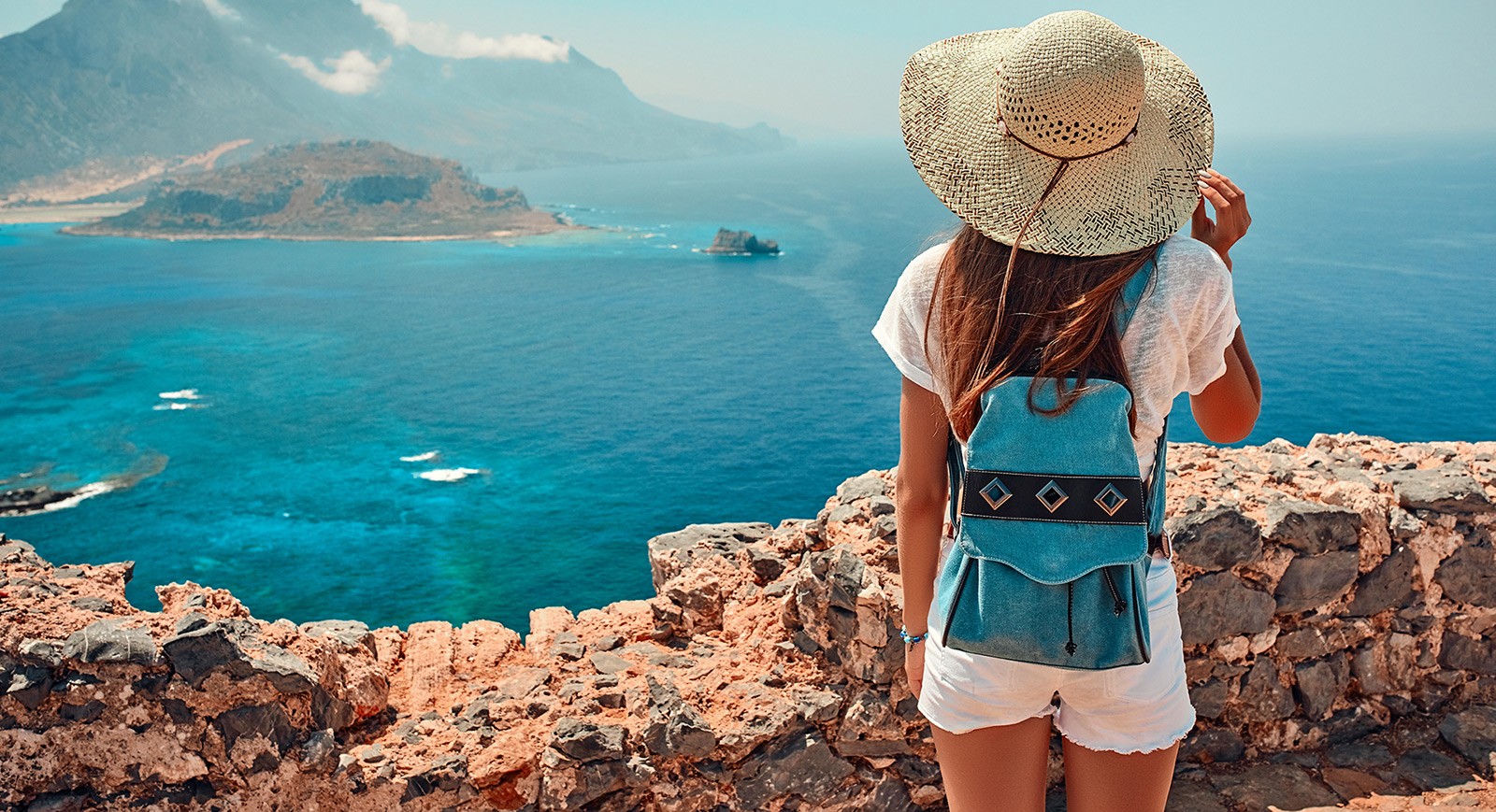 Woman overlooking ocean and mountains