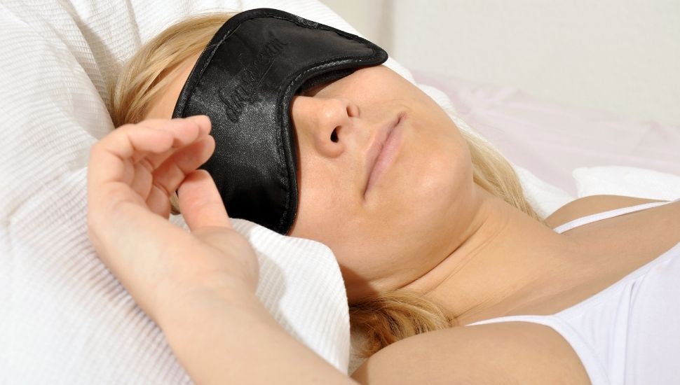 Woman sleeping with sleep mask