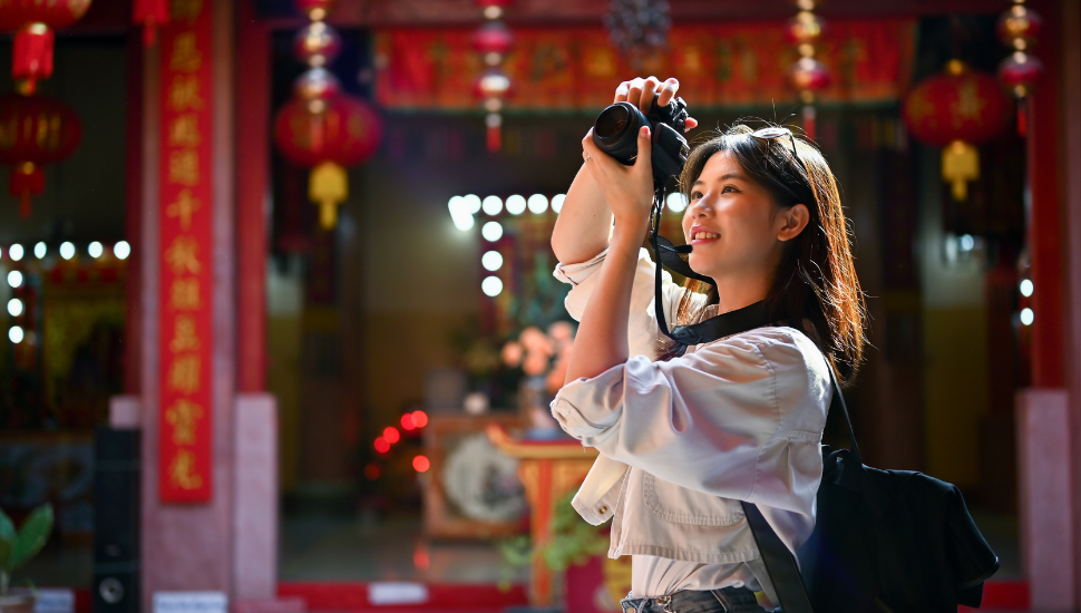 Tourist taking photos at Japanese temple