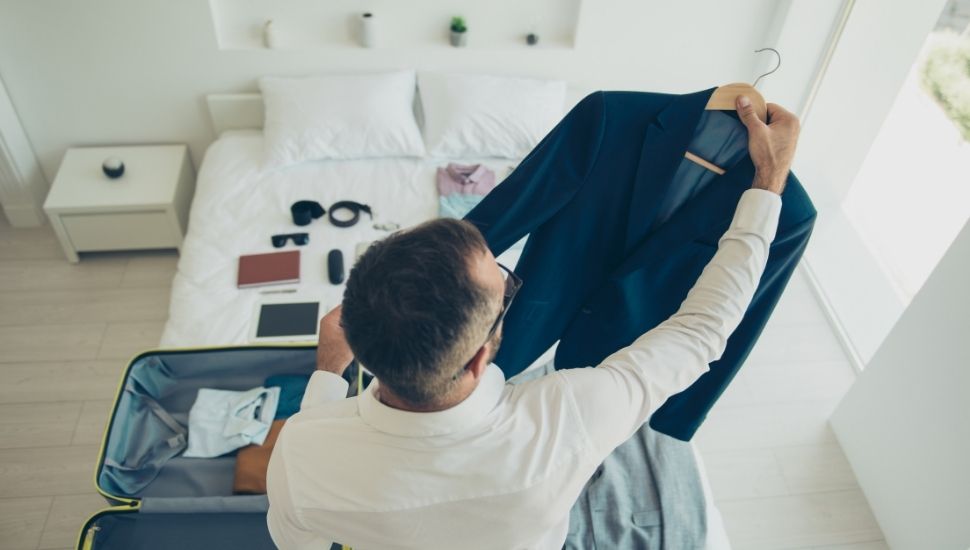 Business man packing suitcase for business trip