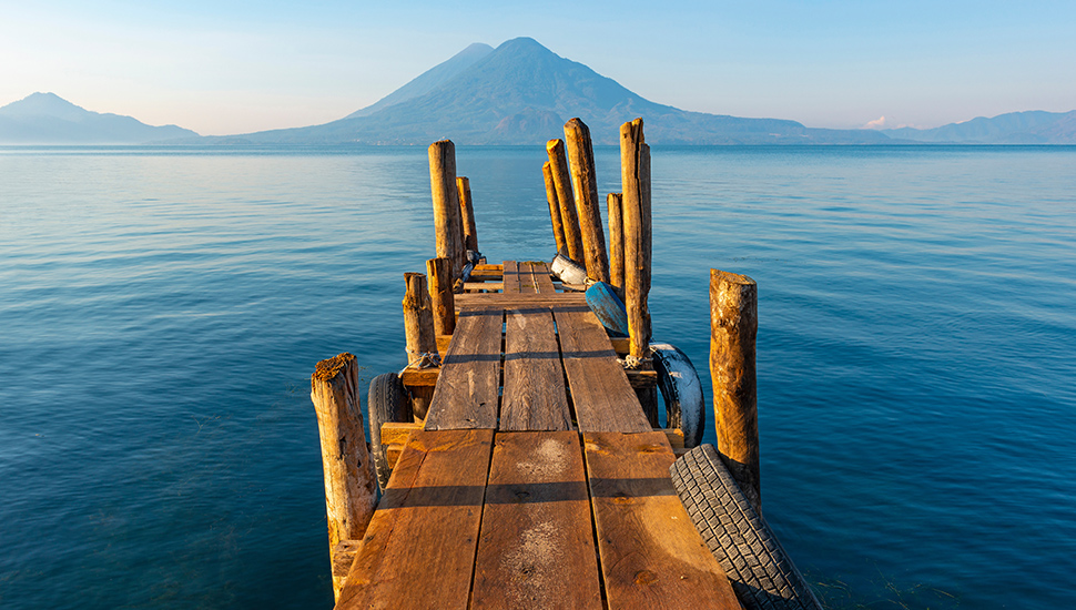 Sunrise by the Atitlan Lake with an embarkation pier, Panajachel, Guatemala.