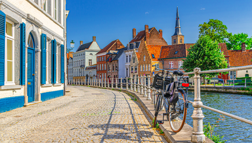 Cycle by canal in Bruges Old Town