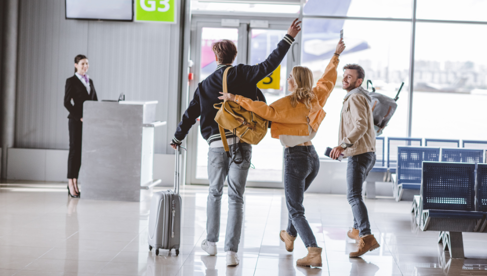 Group of happy friends about to board a flight
