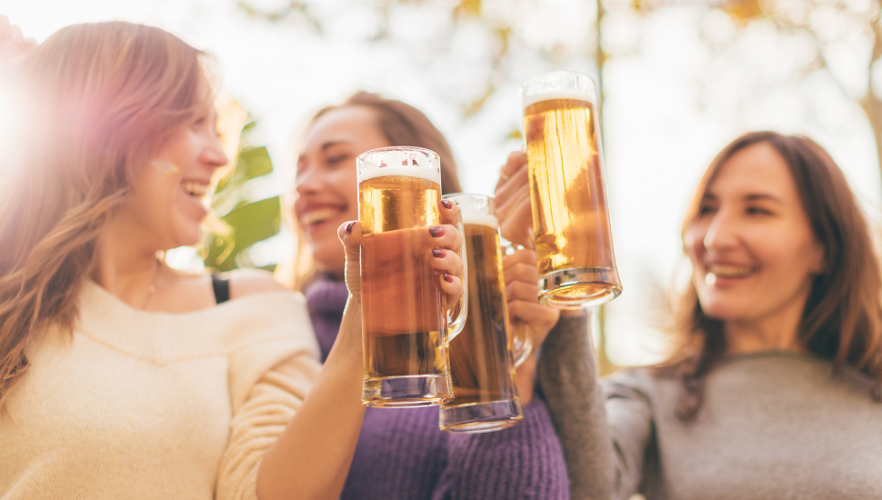 Women drinking steins of beer