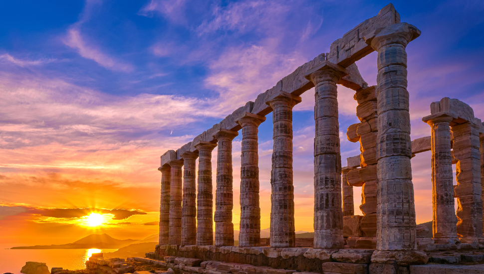 Sunset sky and ancient ruins of temple of Poseidon, Greece