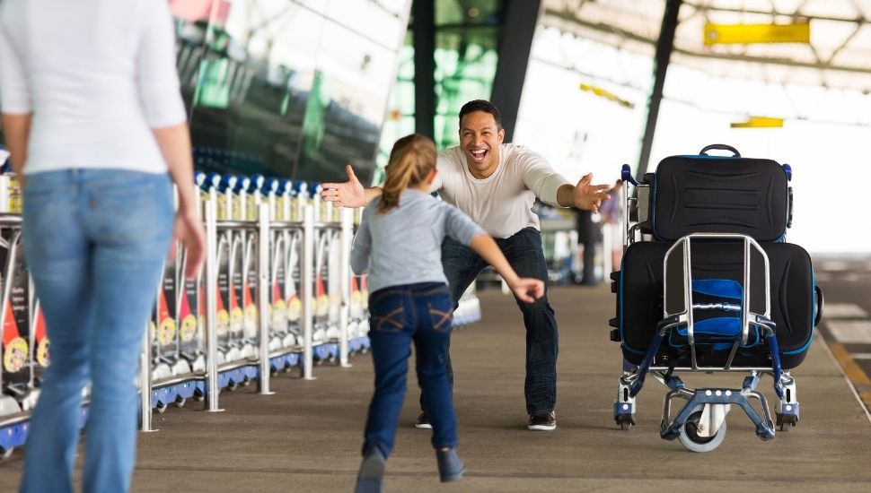 Man greeting daughter at airport
