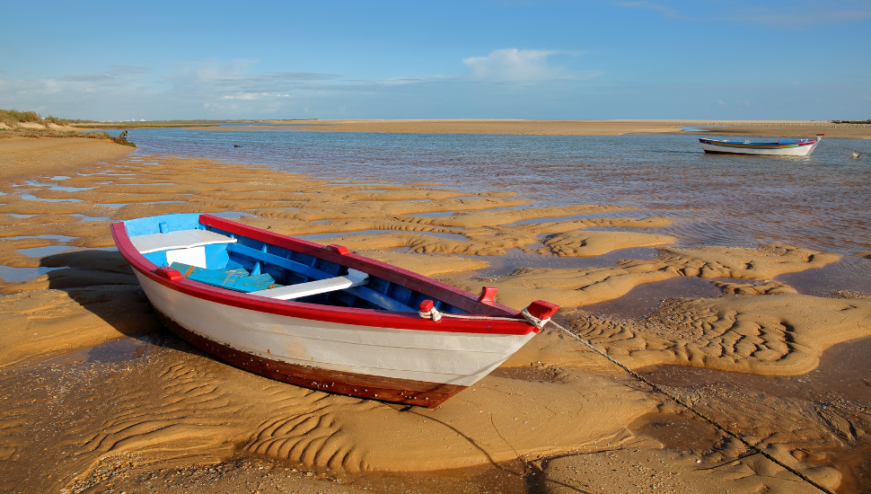 Boat on Beach of Cacela Velha, a small village located near Tavira, Algarve, Portugal