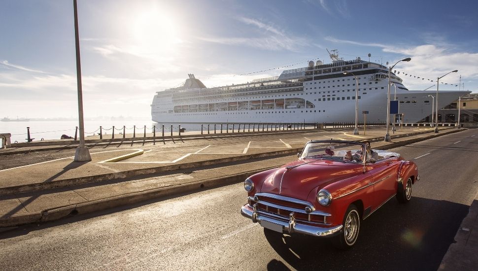 Classic car in Havana, with cruise ship in background