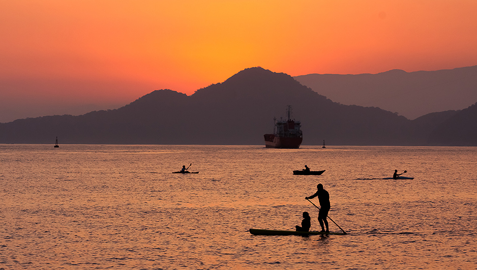 Paddleboarder in front of Sunset in Santos, Brazil.