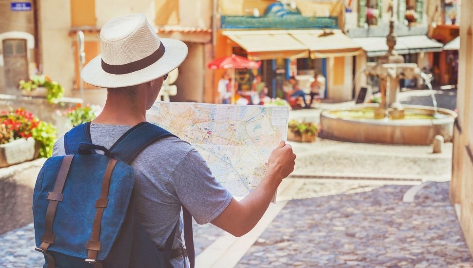 Tourist looking at a map on a street in France