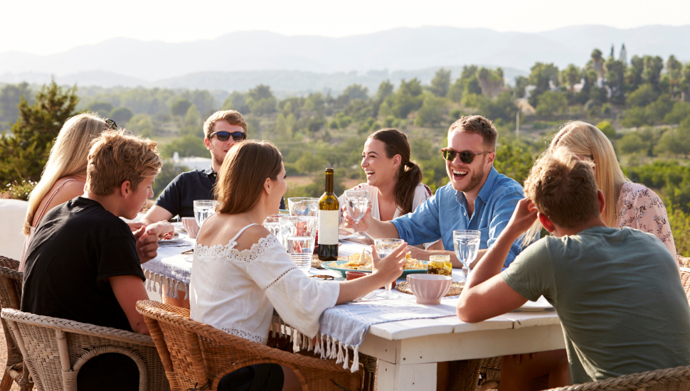 Guided tour group enjoying outdoor meal on holiday