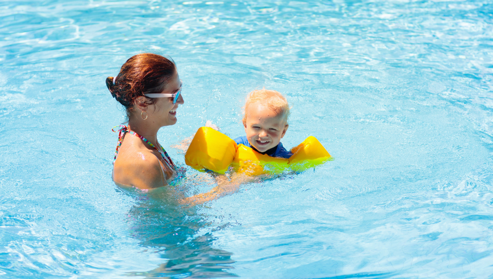 Mum with baby in hotel swimming pool