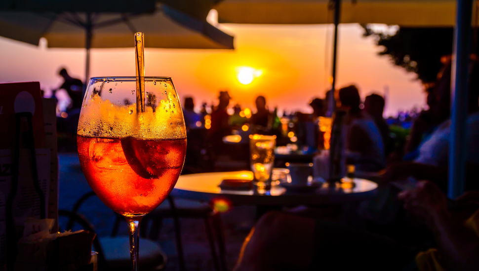 Drinks in bar on holiday at sunset