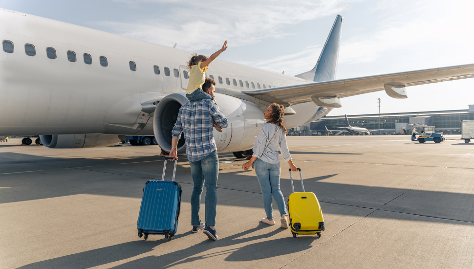 Happy family about to board a plane