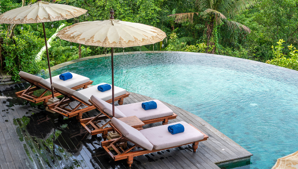 Swimming pool and sunbeds in the tropical jungle near Ubud, Bali, Indonesia