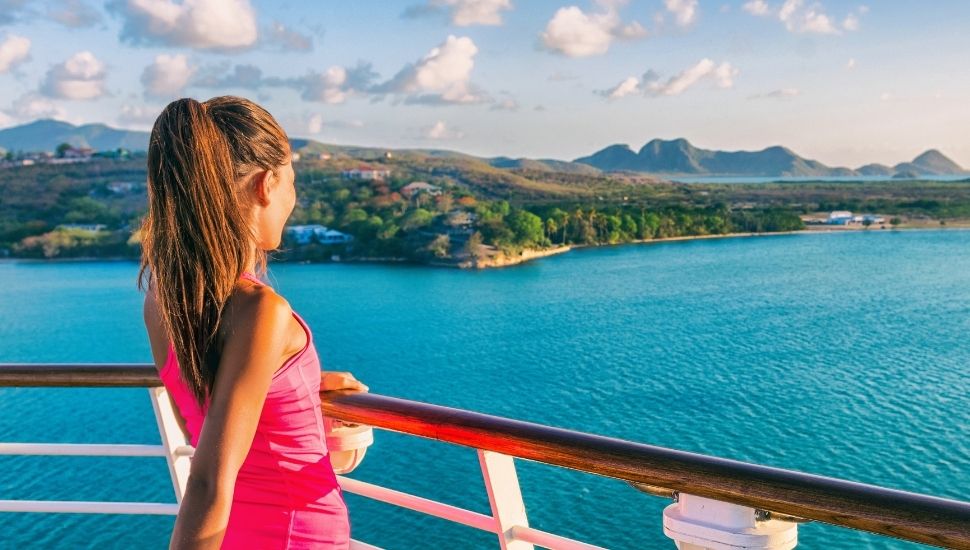 Woman enjoying view as cruise ship leaves port in St Lucia
