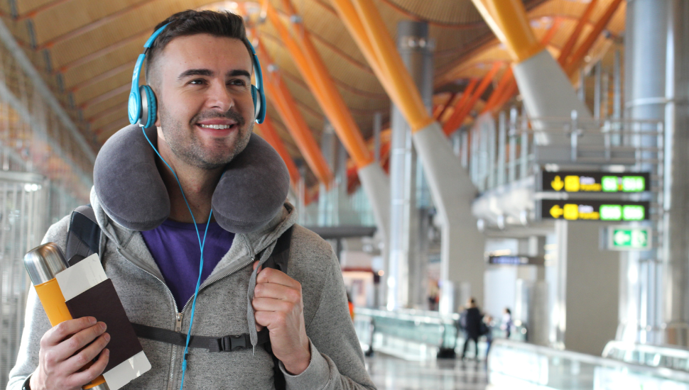 Person with travel pillow at airport