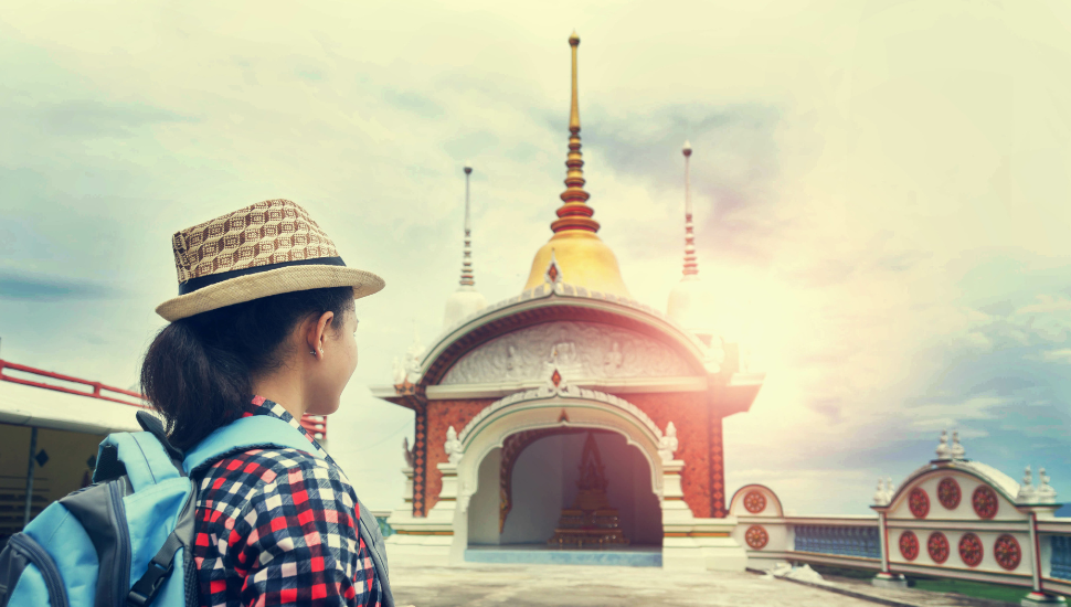 Female backpacker sight-seeing at temple