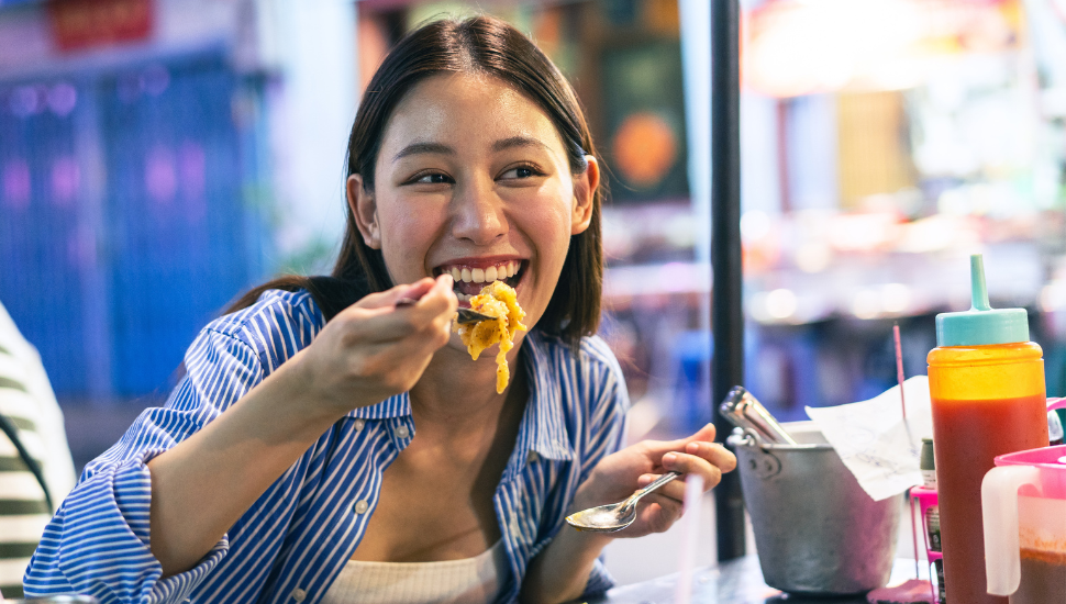 Tourist enjoying Thai street food
