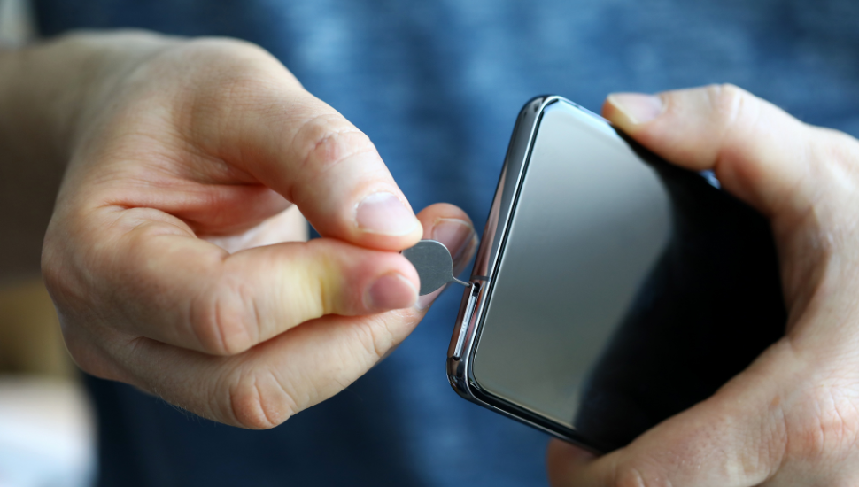 Male changing SIM card in phone